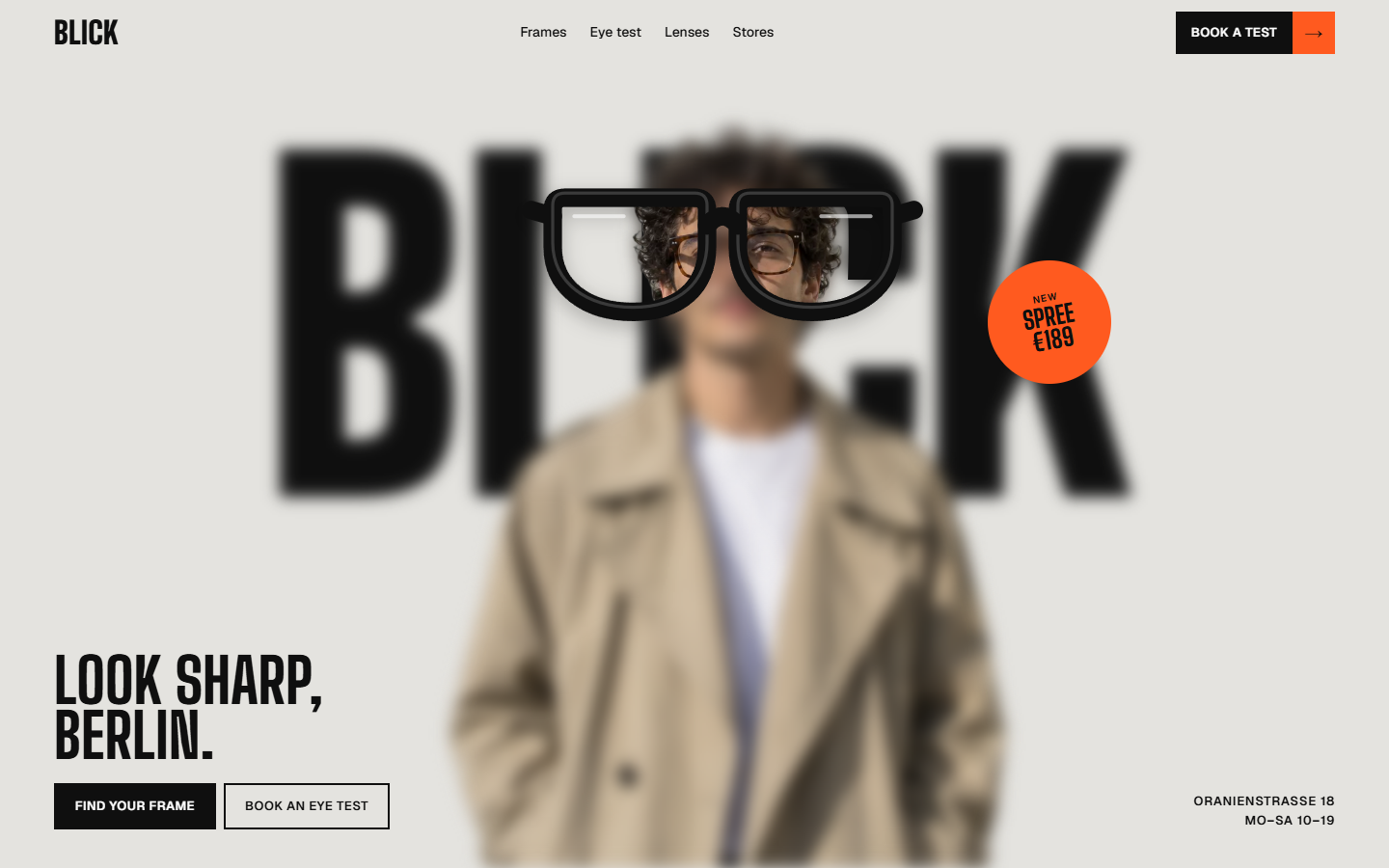 Blick homepage. A man in a beige trench coat stands blurred in front of the giant word “BLICK”; only what shows through a pair of black glasses is sharp. “Look sharp, Berlin.” sits bottom left, with an orange “New · Spree · €189” sticker beside the glasses.